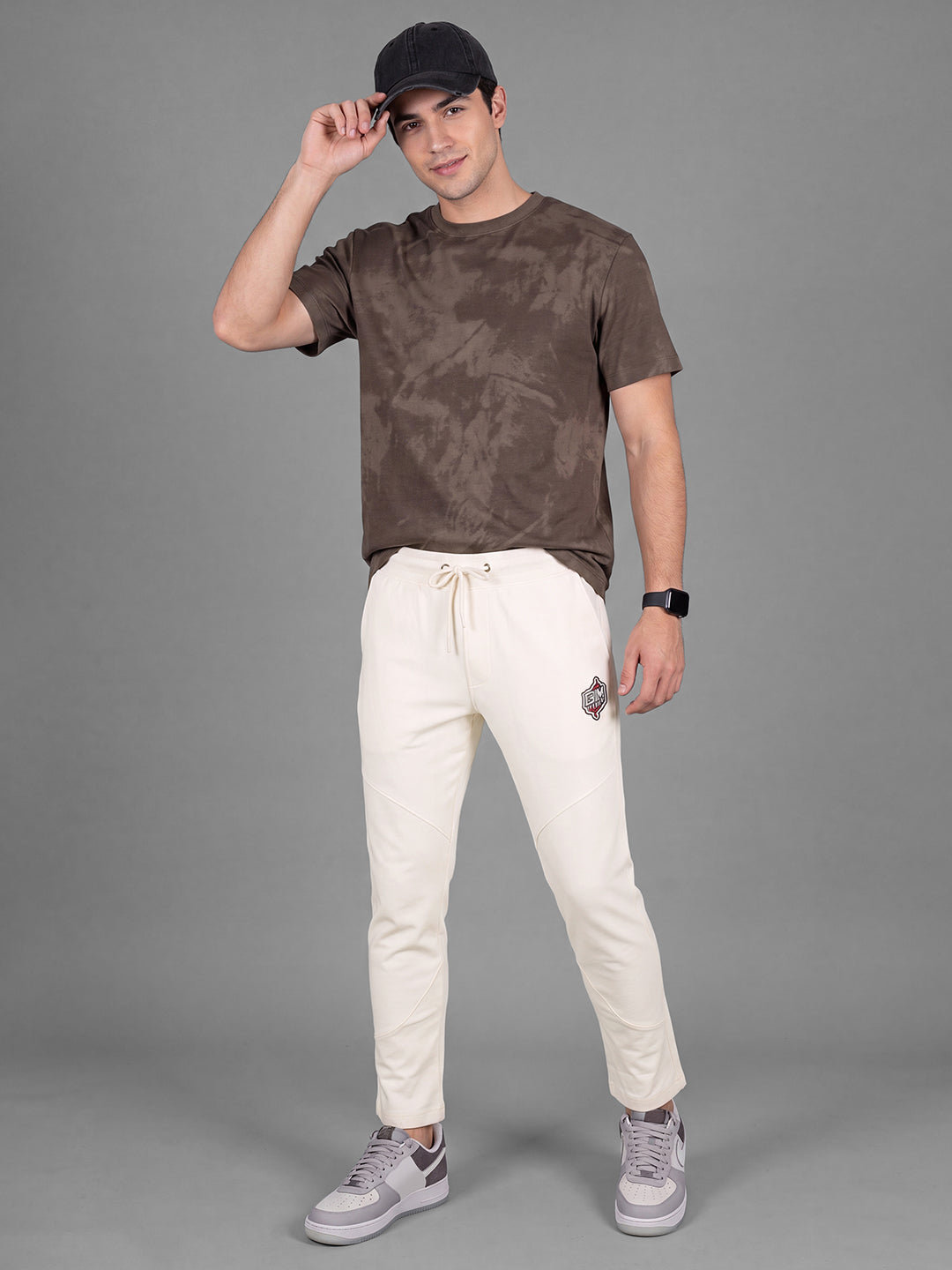 Cream Loose Regular Fit Solid Cotton Blend Mid Rise Men's Track Pants by Being Human Clothing