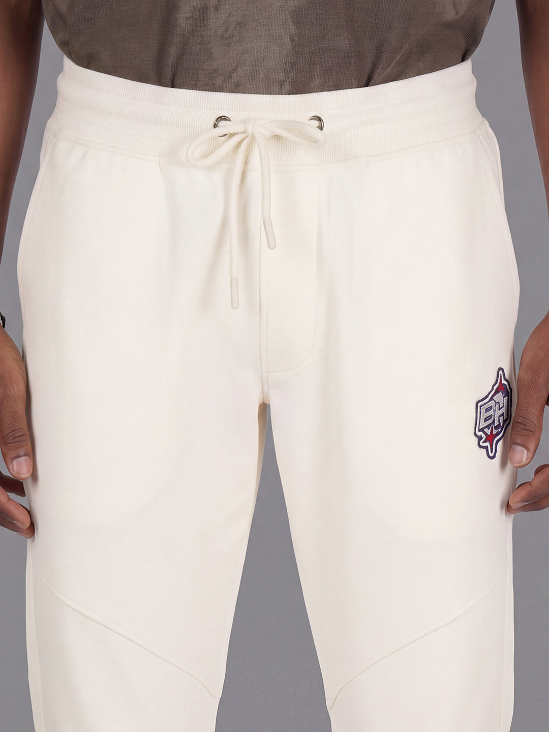 Cream Loose Regular Fit Solid Cotton Blend Mid Rise Men's Track Pants by Being Human Clothing